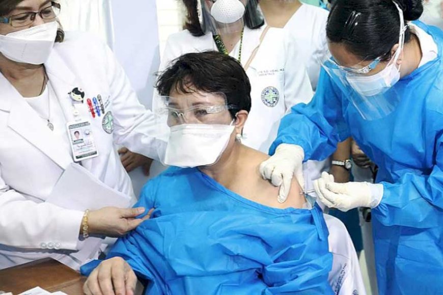 Gemma Colcol, nurse supervisor at the Veterans Memorial Medical Center (VMMC) in Quezon City, gets vaccinated with CoronaVac